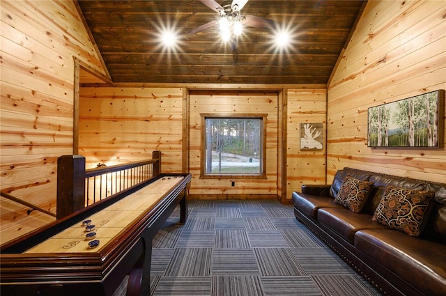 game room with wood ceiling, ceiling fan, wooden walls, dark colored carpet, and lofted ceiling