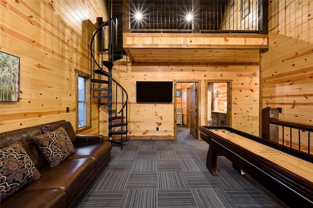 playroom featuring a towering ceiling and wooden walls