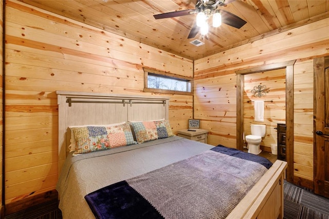 bedroom with connected bathroom, wood walls, ceiling fan, and wood ceiling