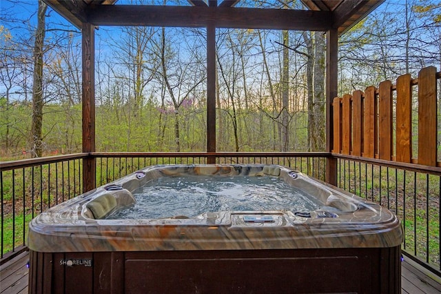 wooden deck with a hot tub