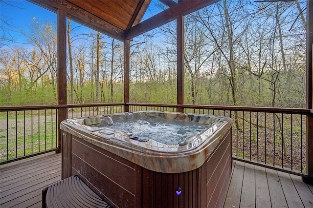 wooden terrace featuring a hot tub