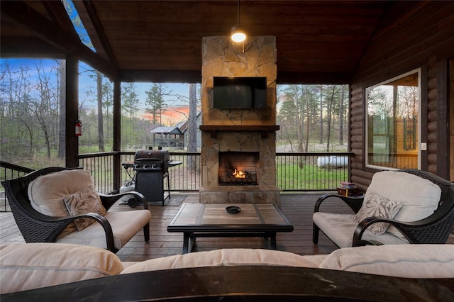 exterior space with an outdoor stone fireplace and a grill