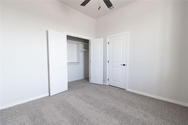 unfurnished bedroom with carpet, ceiling fan, and a closet