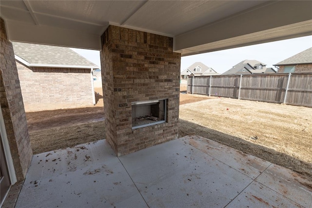 view of patio with an outdoor brick fireplace