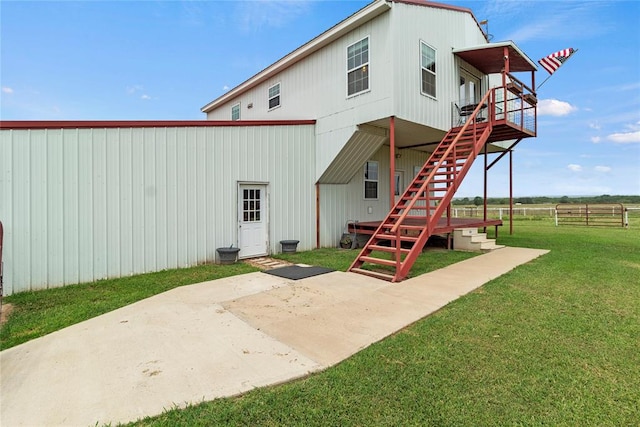 back of house with a patio area, stairs, fence, and a yard