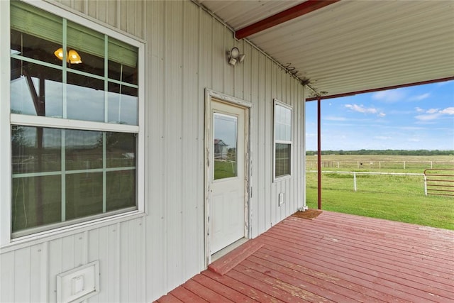 deck featuring a rural view and a lawn