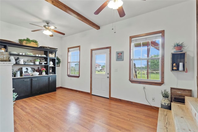 kitchen with beam ceiling, open shelves, light wood-style flooring, dark cabinets, and baseboards