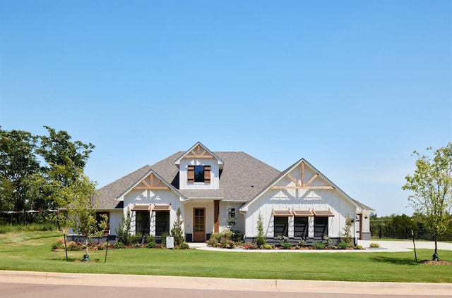 view of front of home with a front lawn and board and batten siding