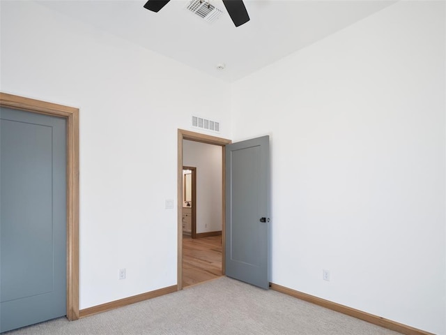 unfurnished bedroom featuring carpet flooring, visible vents, and baseboards