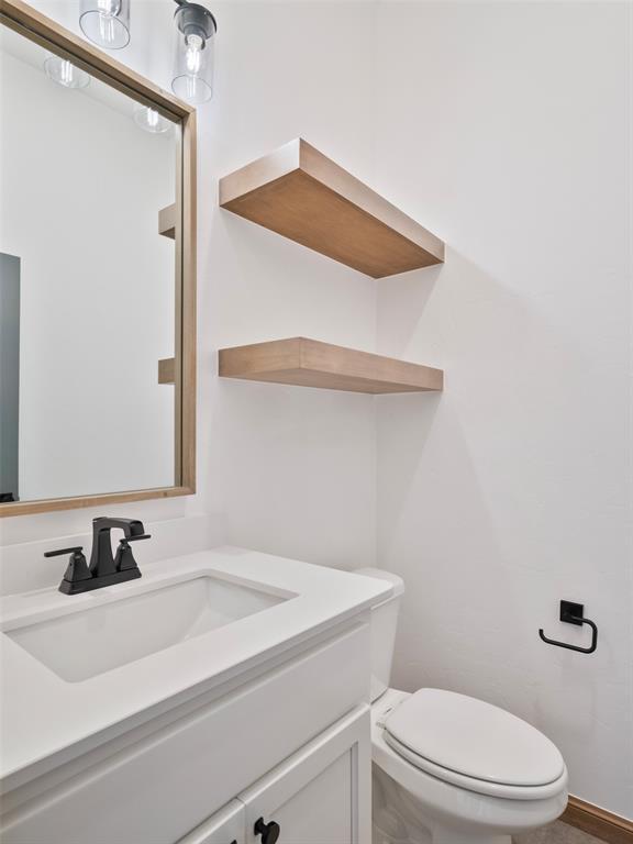 bathroom with toilet and vanity
