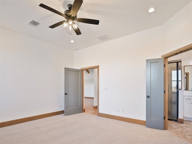 interior space featuring baseboards, visible vents, and light colored carpet