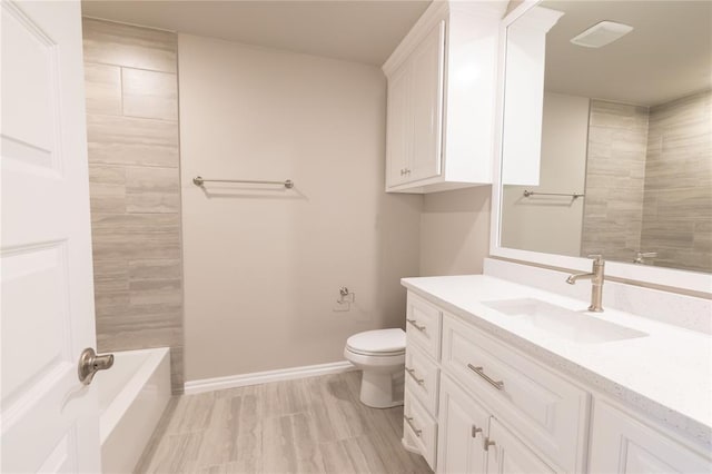 full bathroom featuring toilet, tiled shower / bath combo, and vanity