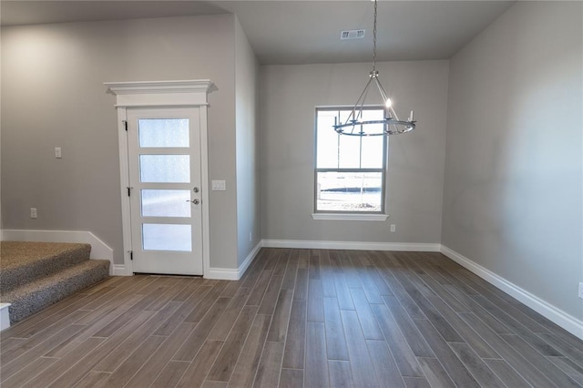 interior space with an inviting chandelier and dark hardwood / wood-style flooring