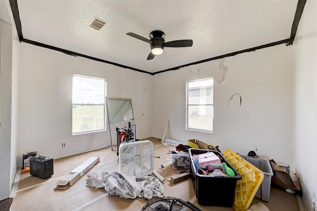 667 County Road 1410th Rd, Ninnekah, OK 73067 - bedroom with ornamental molding, a textured ceiling, and ceiling fan