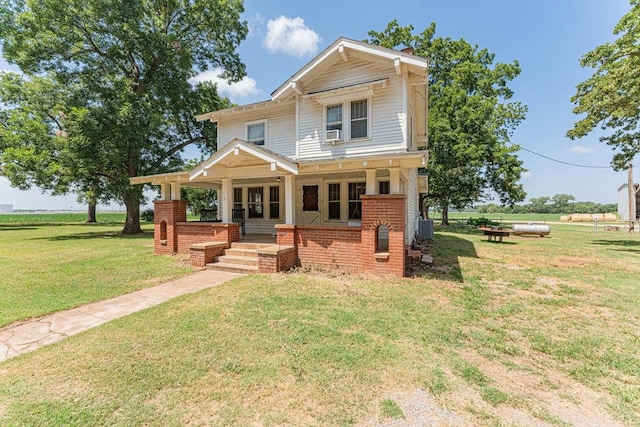 craftsman-style home with central AC unit, a porch, and a front yard