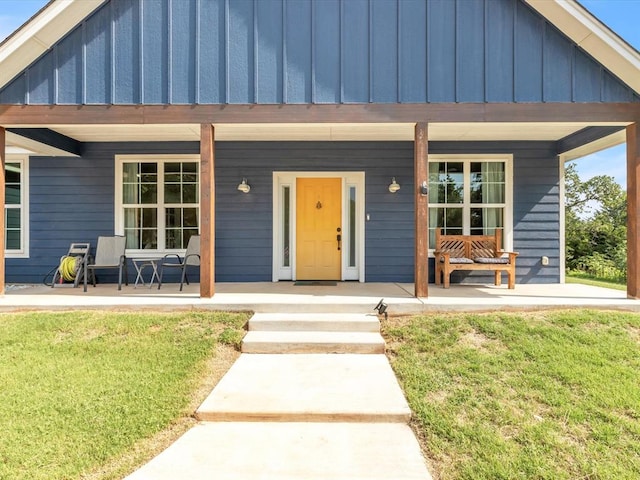 view of front of property with a front yard and a porch