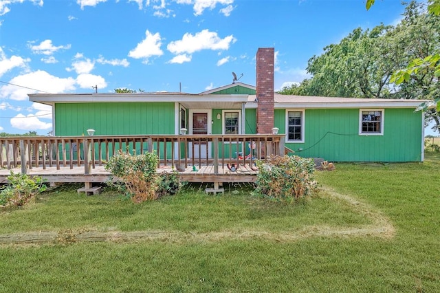 back of house with a wooden deck and a yard