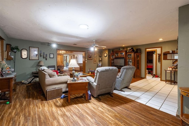 living room featuring ceiling fan and light wood-type flooring