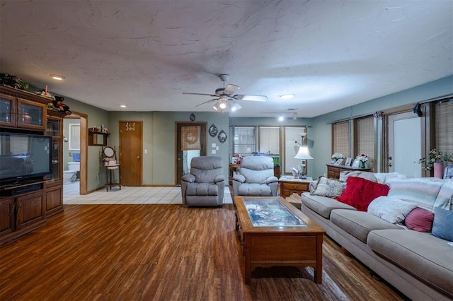 living room with ceiling fan and light hardwood / wood-style floors