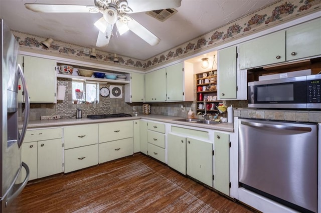 kitchen featuring stainless steel appliances, ceiling fan, dark wood-type flooring, and sink