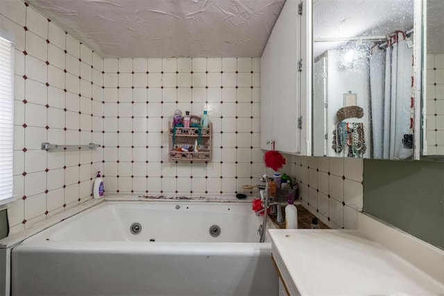 bathroom with vanity, plenty of natural light, and a bath