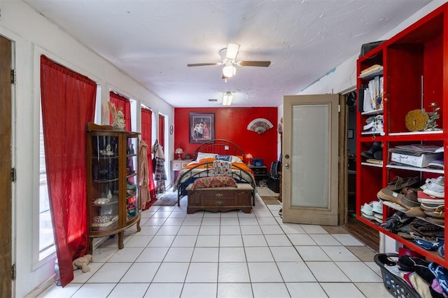 tiled bedroom with ceiling fan