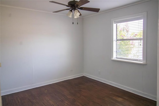 spare room with crown molding, ceiling fan, and dark wood-type flooring