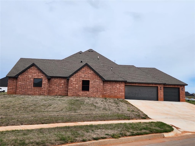 9320 SW 34th St, Oklahoma City, OK 73179 - view of front of property featuring a shingled roof, an attached garage, brick siding, and concrete driveway