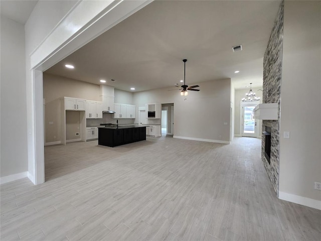 9320 SW 34th St, Oklahoma City, OK 73179 - living area featuring a ceiling fan, a stone fireplace, baseboards, recessed lighting, and light wood-style flooring