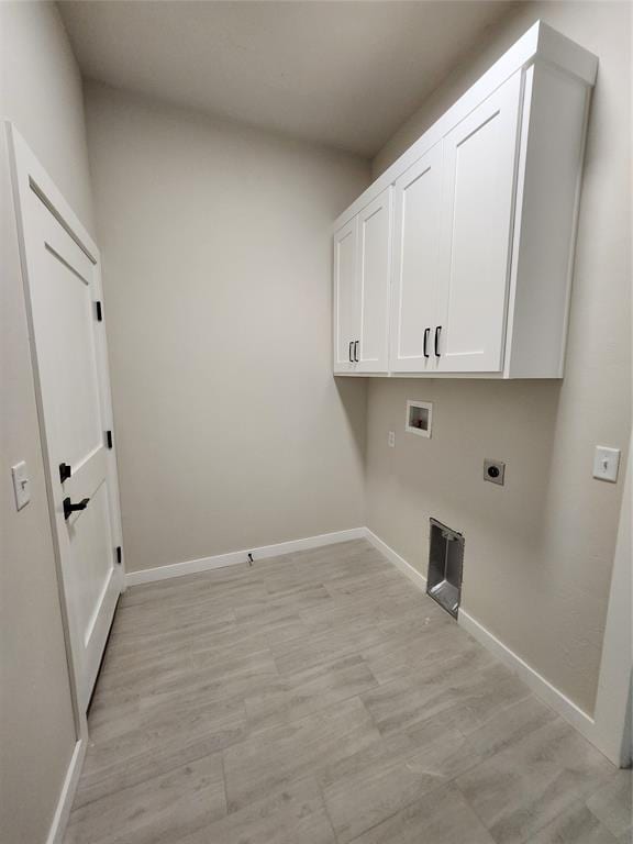 clothes washing area featuring electric dryer hookup, hookup for a washing machine, and cabinets