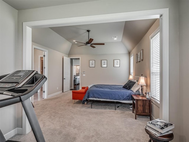 carpeted bedroom featuring ceiling fan, lofted ceiling, and ensuite bathroom