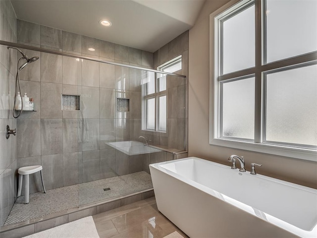 bathroom featuring tile patterned flooring and separate shower and tub