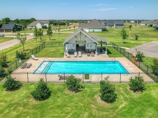 view of swimming pool with an outbuilding, a patio area, and a lawn