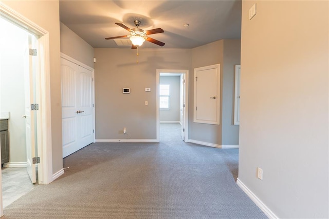 carpeted empty room featuring ceiling fan