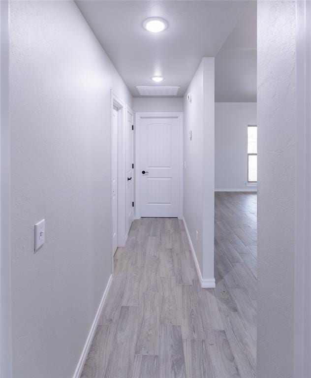 corridor featuring light hardwood / wood-style floors