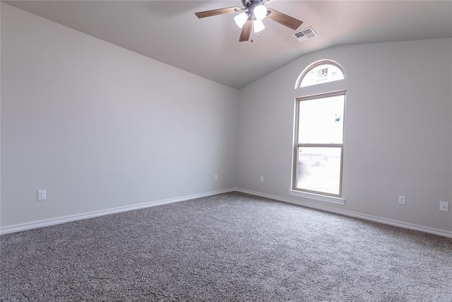 carpeted spare room with vaulted ceiling, plenty of natural light, and ceiling fan