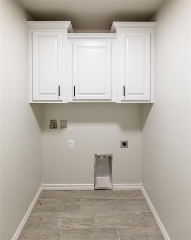 clothes washing area featuring hookup for an electric dryer, light wood-type flooring, and washer hookup