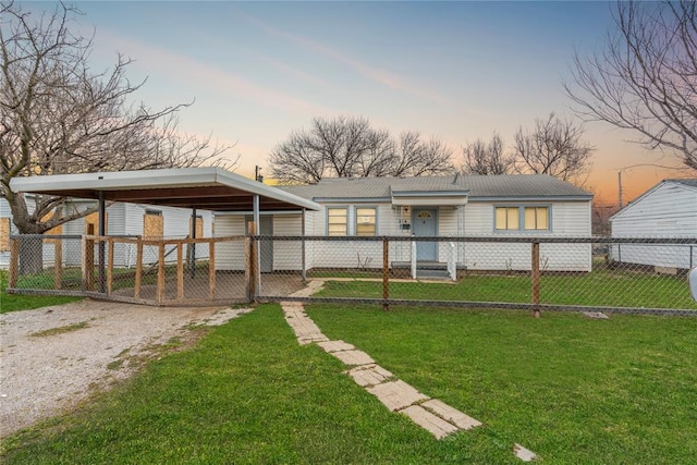 yard at dusk featuring a carport