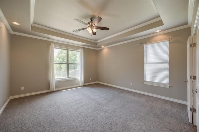 carpeted empty room featuring a tray ceiling, ceiling fan, and ornamental molding