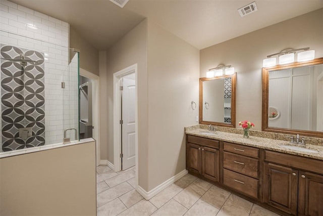 bathroom with tile patterned flooring, vanity, and walk in shower