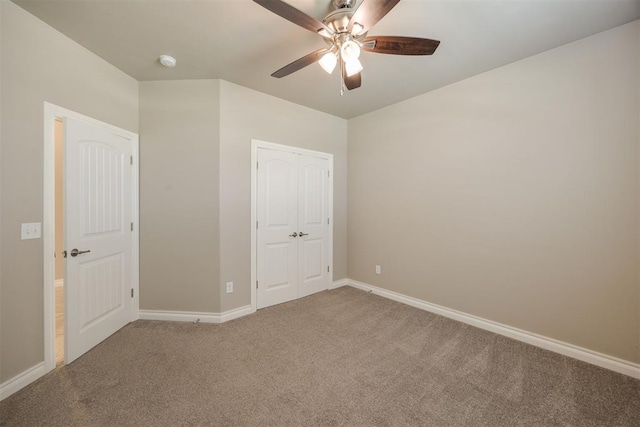 unfurnished bedroom with carpet flooring, ceiling fan, and a closet