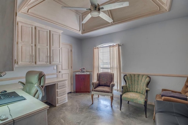 home office with a raised ceiling and ceiling fan