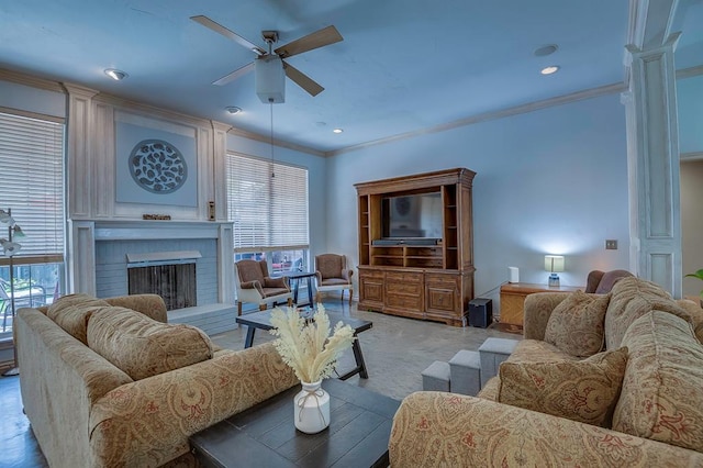 living room featuring ceiling fan, ornamental molding, and a fireplace