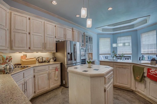 kitchen featuring appliances with stainless steel finishes, tasteful backsplash, crown molding, pendant lighting, and a kitchen island