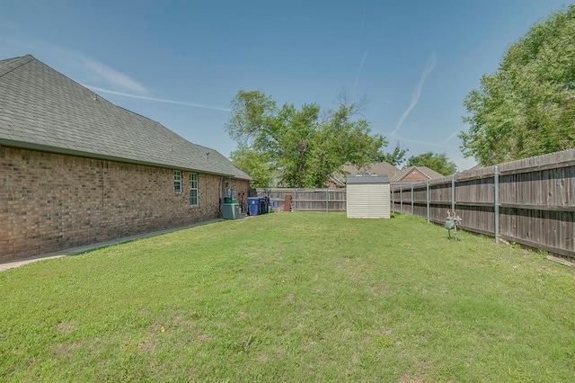 view of yard with a storage shed and central air condition unit