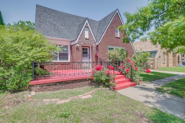 tudor home featuring a front yard