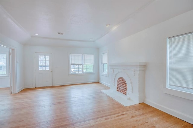 unfurnished living room with vaulted ceiling and light hardwood / wood-style flooring