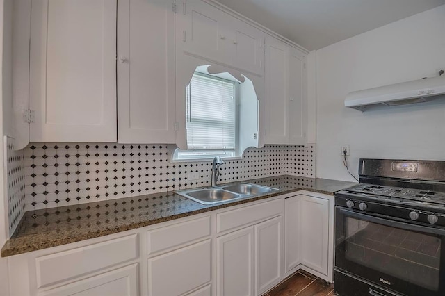 kitchen with backsplash, black range with gas stovetop, sink, and white cabinets