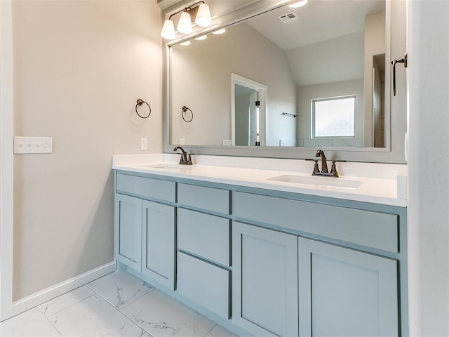 bathroom featuring vanity and vaulted ceiling