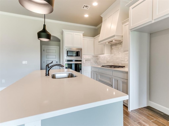 kitchen with white cabinetry, sink, stainless steel appliances, light hardwood / wood-style floors, and custom exhaust hood